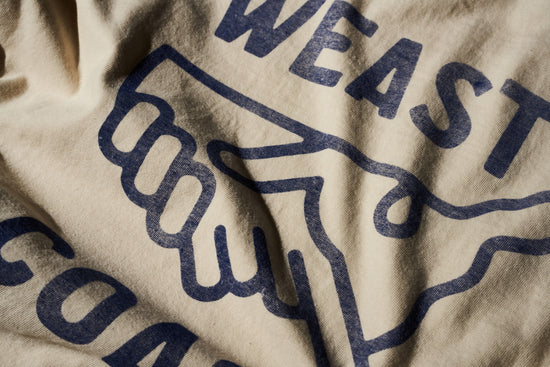 detail shot of cream t-shirt with faded blue graphic