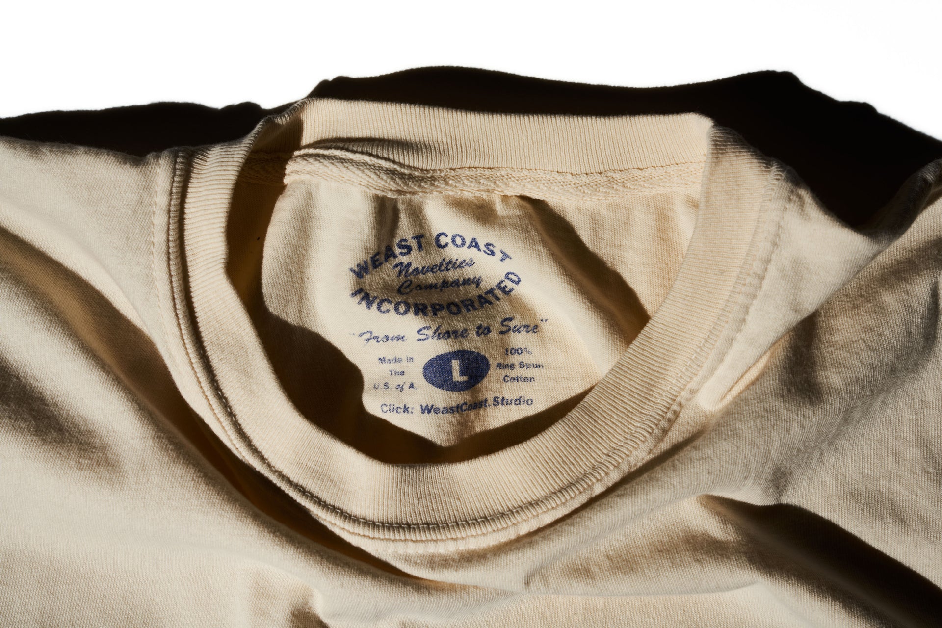 detail shot of cream t-shirt with faded blue graphic