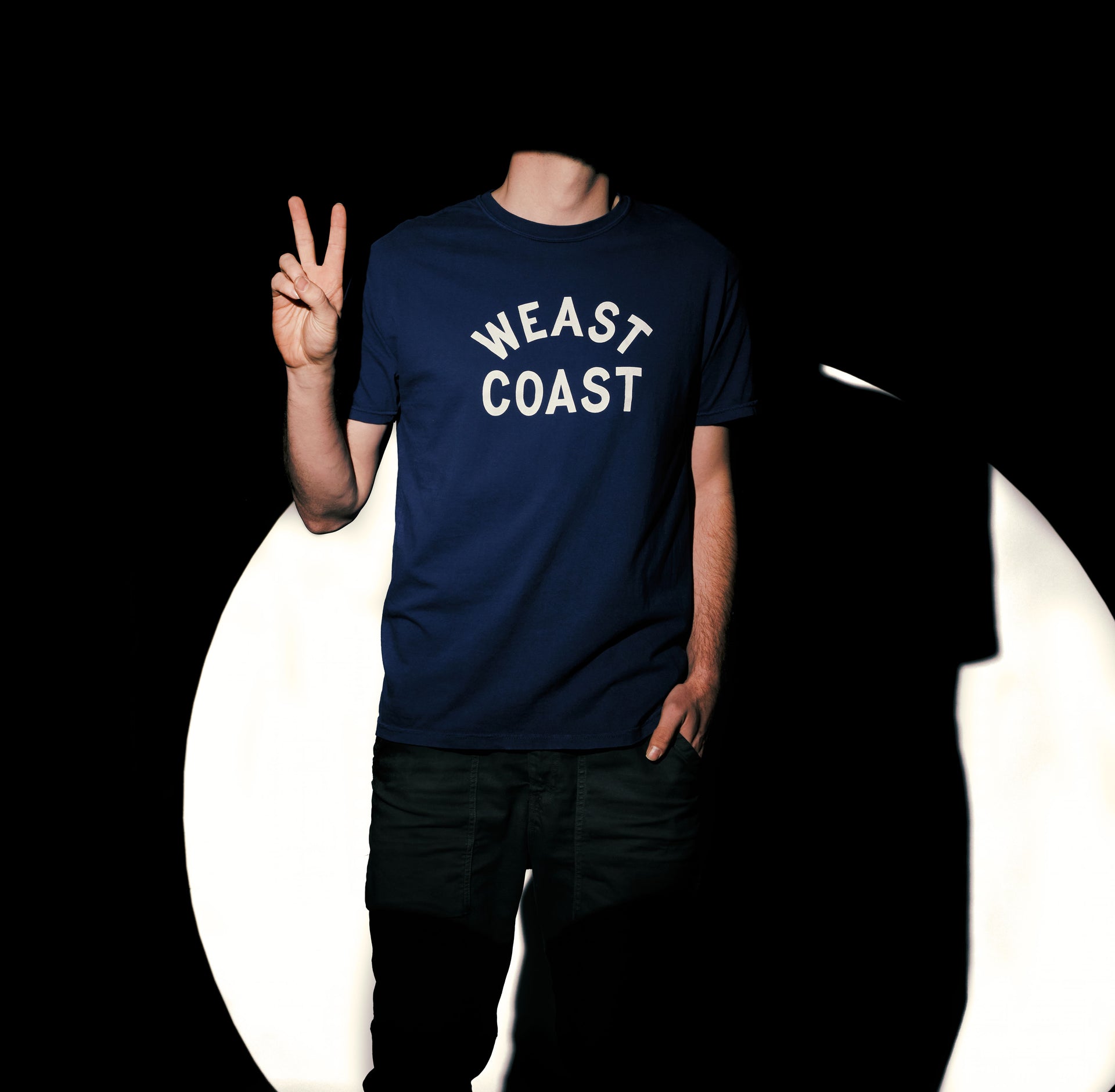 model wearing Navy t-shirt with crackle print weast coast arched letters